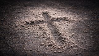 Ash Wednesday Cross Made of Ash on Dark Ground